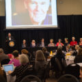 President Emeritus Aubrey Lucas at podium, Paul O. Zelinsky, Louise Borden, Chuck Galey, Patsy Perritt, Cheryl Peck (Richard's sister), Sonya Sones, Bennett Tramer and Maryann Macdonald.